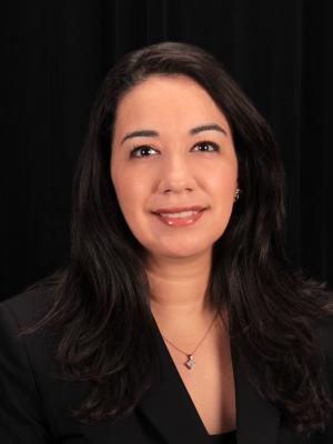 Principal Anabel Romero in front of black background